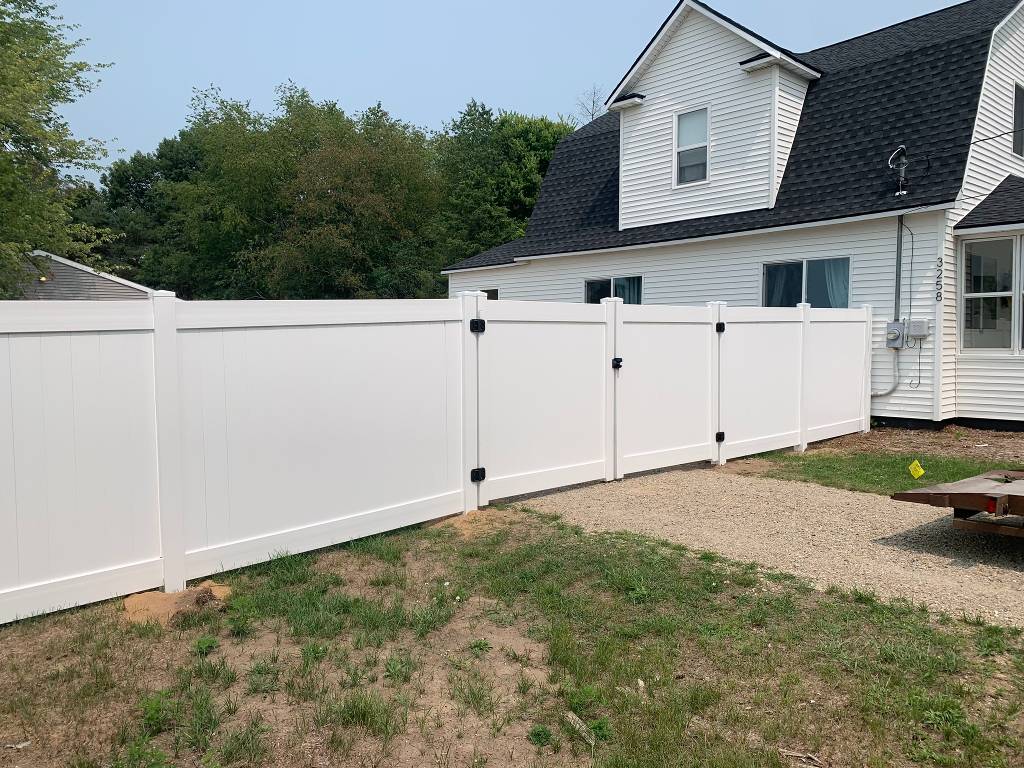 White residential vinyl privacy fence